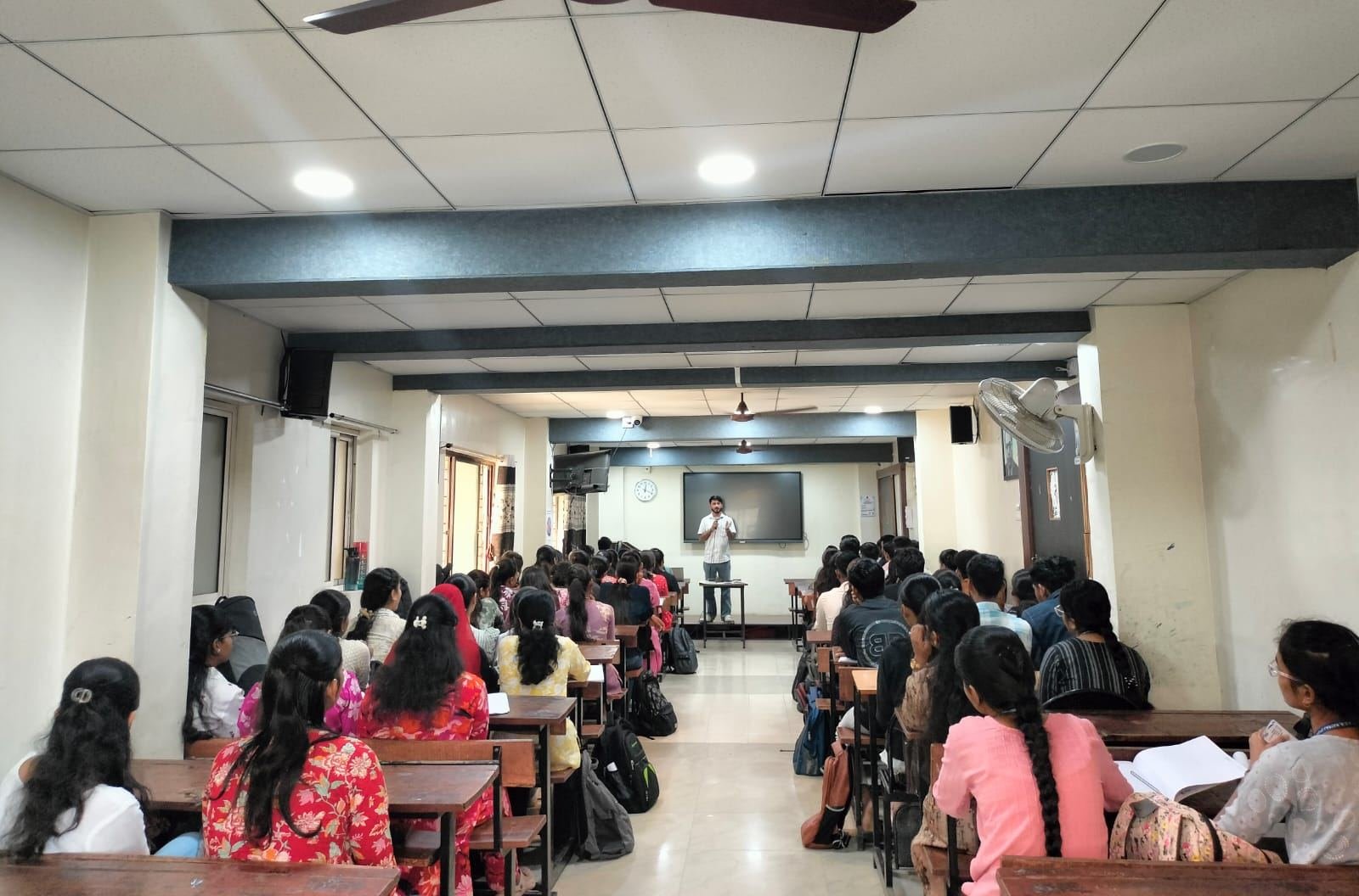A full lecture hall of students at a TheOFCO workshop